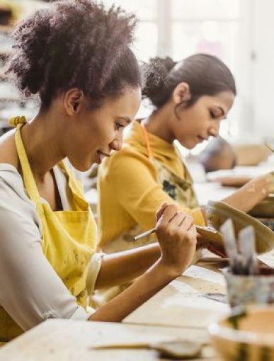 Two people in a pottery class